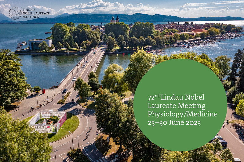 A road leads across a lake to an island. The words '72nd Lindau Nobel laureate meeting, physiology/medicine, 25-20 June 2023' are shown