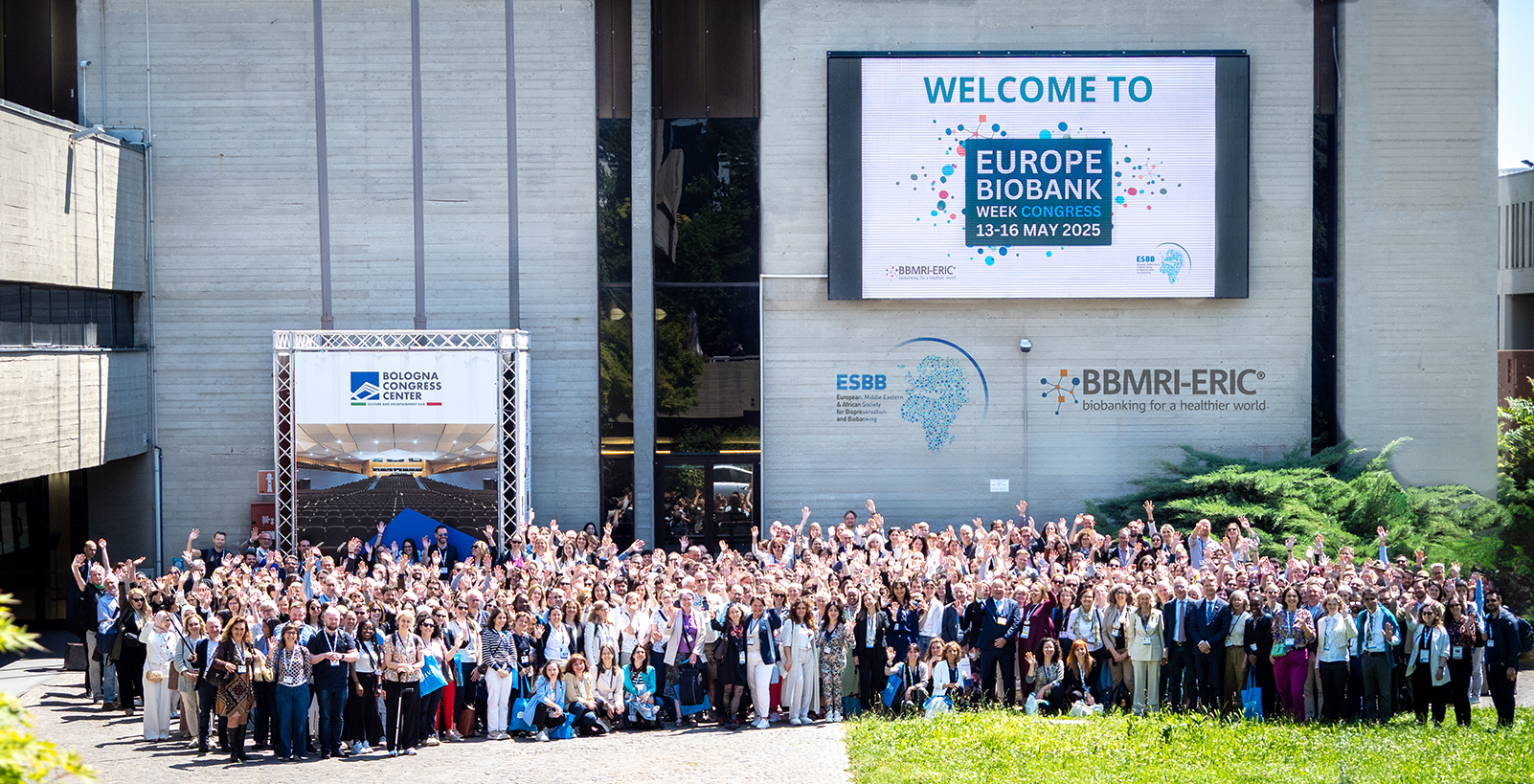 The picture of a group of people attending EBW25. They are all waving at the camera.